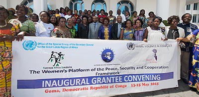 The Women's Platform of the Peace, Security & Cooperation Framework Inaugural Grantee Convening. Group holding banner.