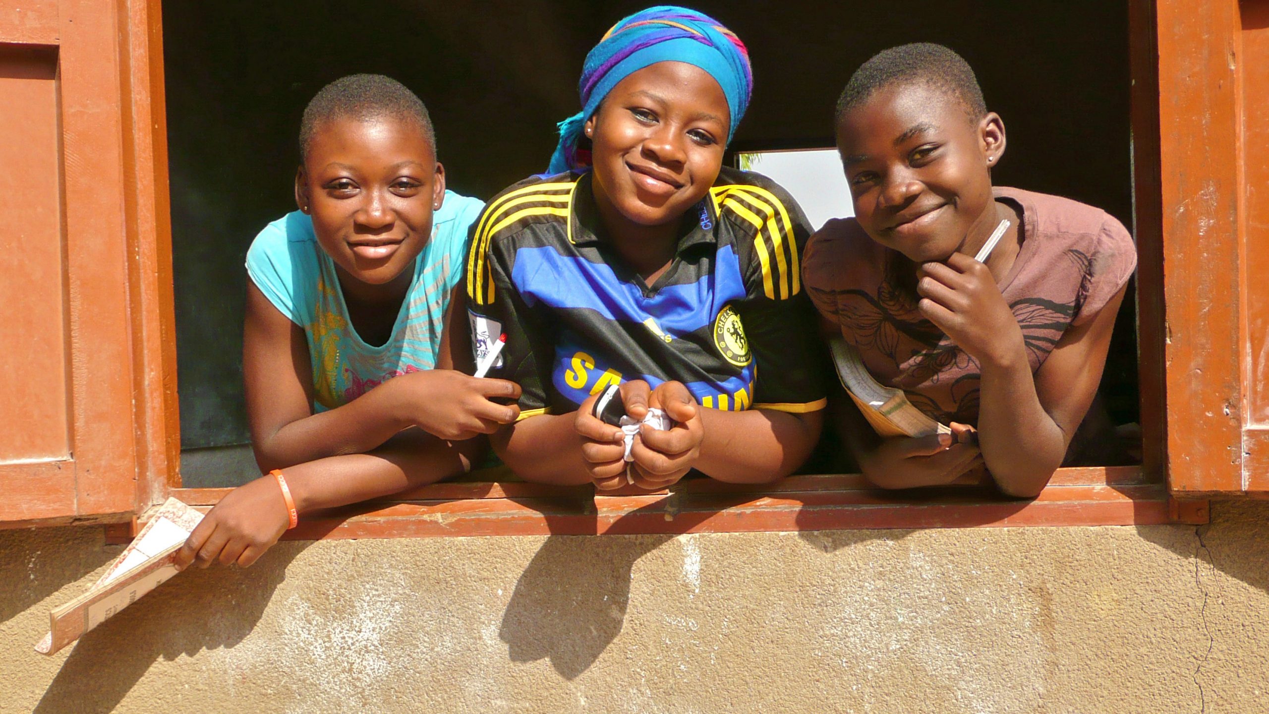 Three schoolgirls in Ghana. Photo copyright Paula Stromberg.
