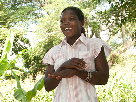 Beneficiary of women's agriculture project in Uganda speaks to her community