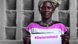 Yeri, a farmer in Burkina Faso, holding a #Determined sign