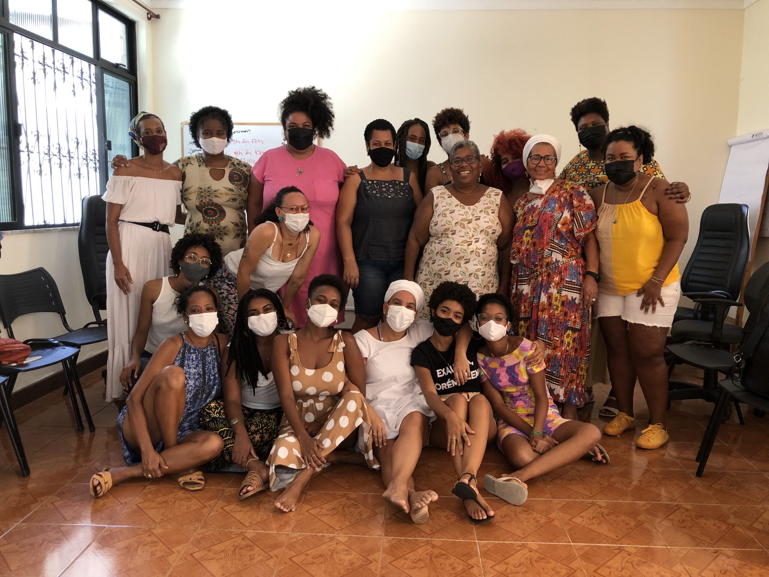 A group photo at the ODARA—Instituto da Mulher Negra headquarters. The group met to develop a network focused on ending racial and gender violence in Bahia. The first row is sitting and the second is standing. Most are wearing face masks.